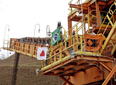 Workers from CVRD display Minas Gerais State flag, Brazilian flag and CVDR flag during opening ceremony of Brucutu mine in Sao Goncalo do Rio Abaixo